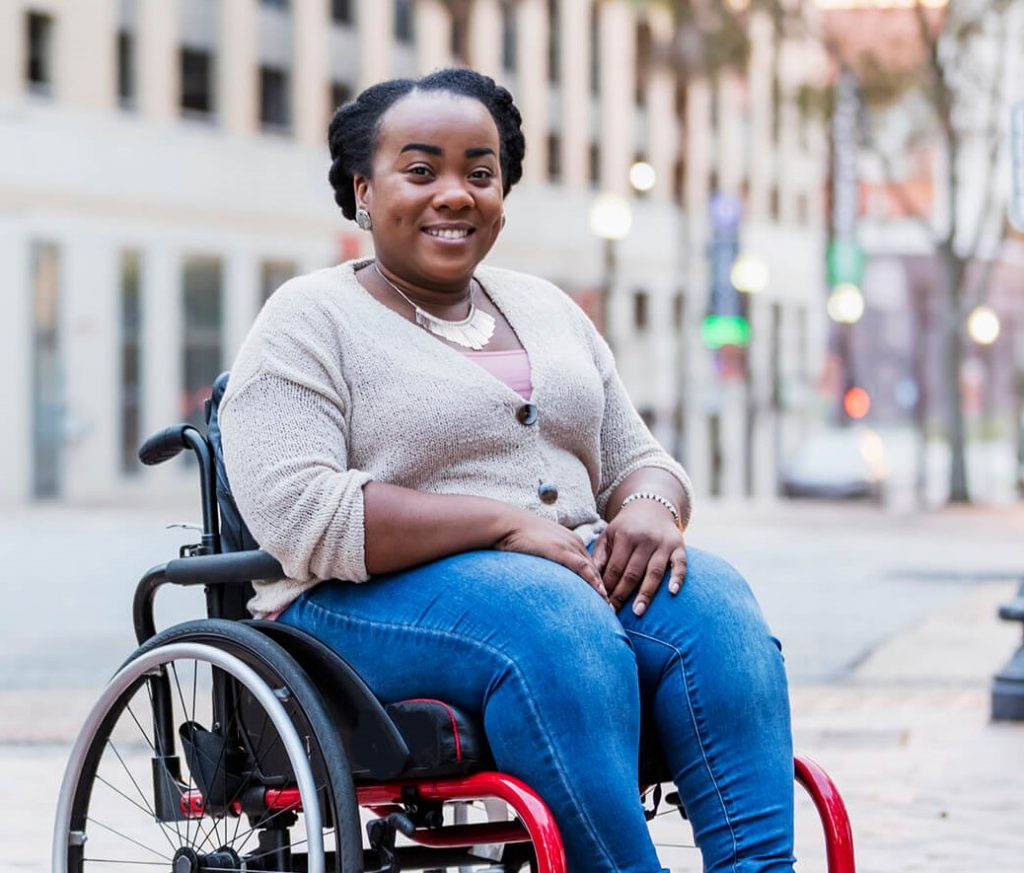 Lady in a wheelchair smiling at the camera